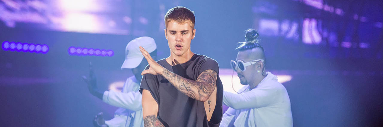 Justin Bieber performs onstage in front of backup dancers