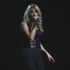 Carrie Underwood performs onstage in a black outfit.