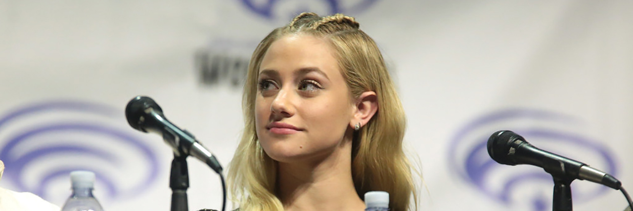 Lili Reinhart Tweets About Why You Shouldn't Minimize Mental Illness Lilli Reinhart looks into the distance at a panel.