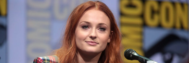 Sophie Turner looks ahead while sitting on a panel