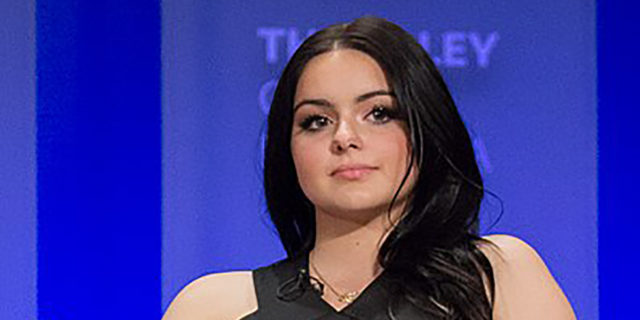 Ariel Winter wears a black dress while sitting on a panel
