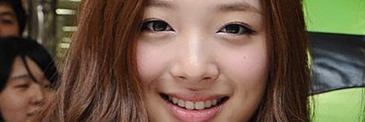 K-Pop Star and Actor Sulli Dies by Suspected Suicide at 25 Sulli posing for a fan's photo in a crowd