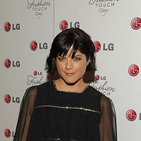 Selma Blair poses in a black dress on the red carpet