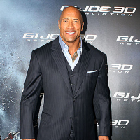 The Rock poses on the red carpet in a suit