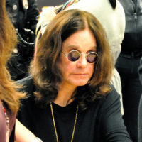 A picture of Ozzy Osbourne surrounded by a crowd
