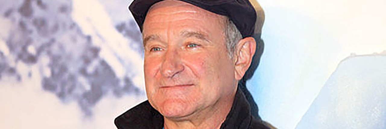 Robin Williams smiles while on the Happy Feet red carpet