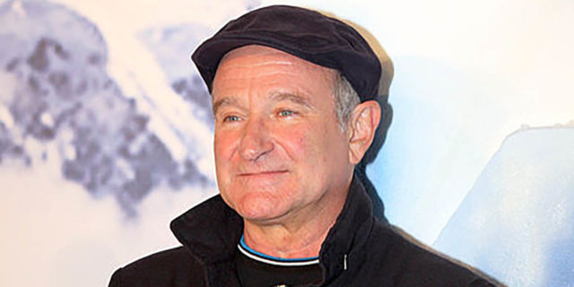 Robin Williams smiles while on the Happy Feet red carpet