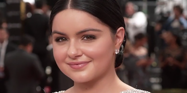 Ariel Winter poses on the red carpet while wearing a silver dress