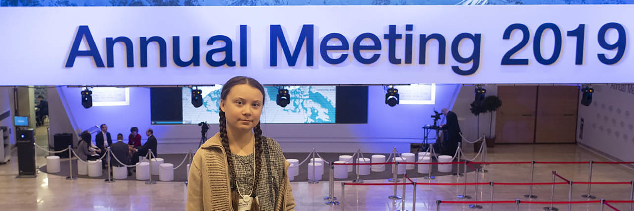Michael Knowles Says Greta Thunberg Is 'Mentally Ill' on Fox News Greta Thunberg poses in front of a sign at a summit