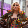 Kesha poses in a bodysuit while perfoming outside