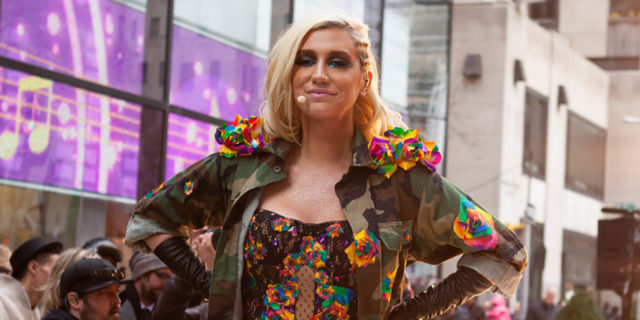 Kesha poses in a bodysuit while perfoming outside