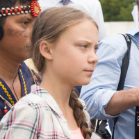 Greta Thunberg looks ahead while at a rally