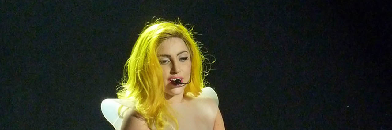 Lady Gaga Confirms She Has Fibromyalgia Lady Gaga holds a bouquet of flowers onstage