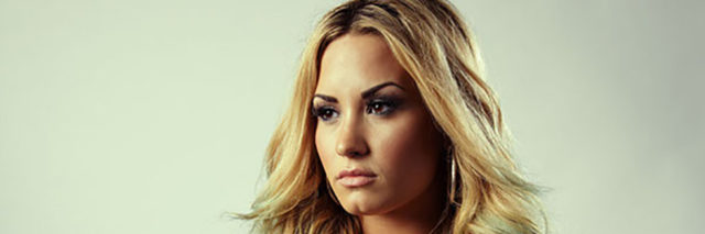 A profile shot of Demi Lovato in a black outfit
