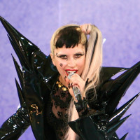 Lady Gaga performs while wearing a black ensemble