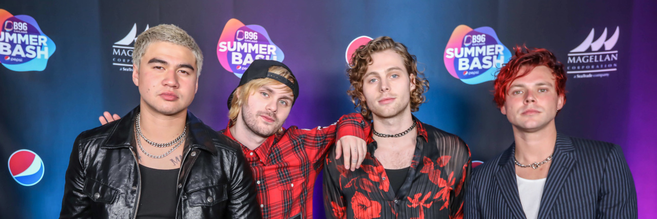 Members of 5 Seconds of Summer pose on the red carpet