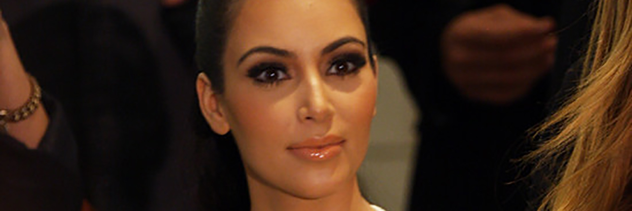 People Call Out Kim Kardashian for Weight Loss 'Compliments' Kim Kardashian wearing a white dress at fashion week