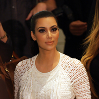 Kim Kardashian wearing a white dress at fashion week