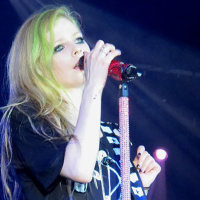Avril Lavigne sings while wearing a black outfit