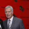 Alex Trebek poses while on the red carpet