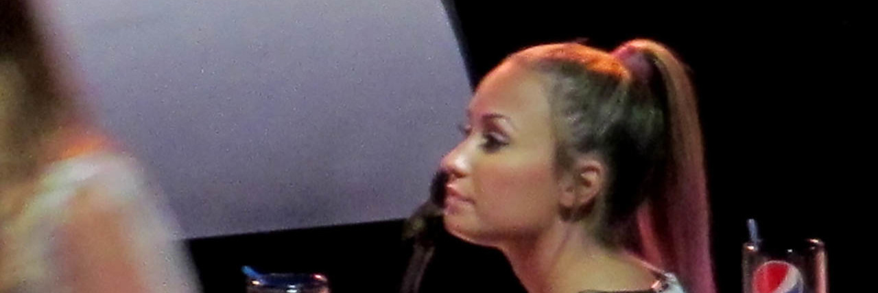 Demi Lovato looking of camera while on a judging panel