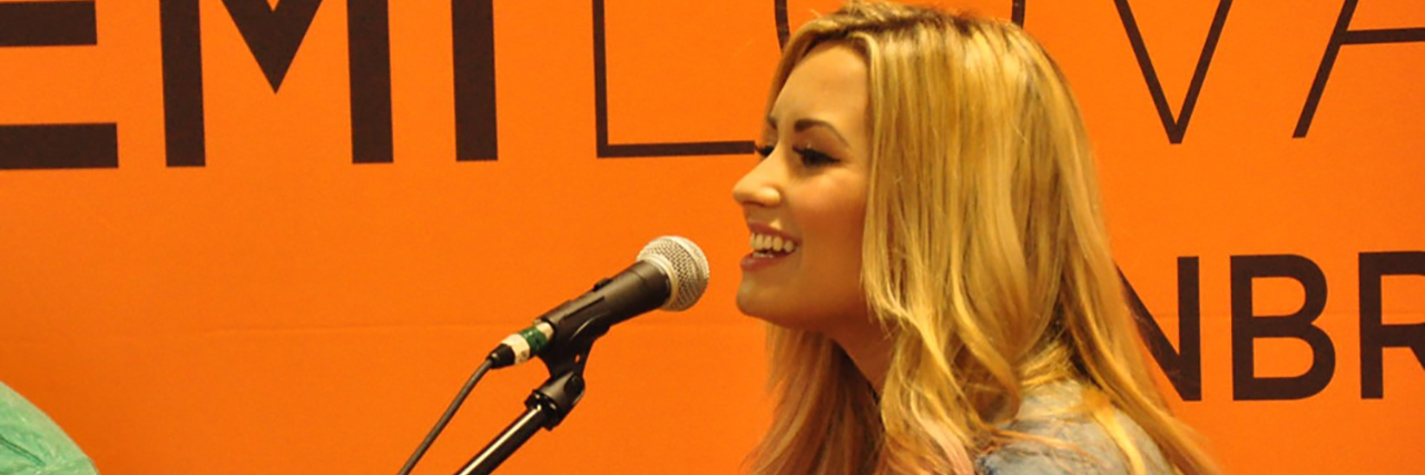 Demi Lovato Gets Vulnerable in New Song 'Sober' A side shot of Demi Lovato, who is talking into the microphone while wearing a denim jacket