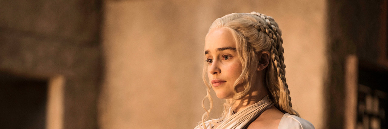 Emilia Clarke Writes About Having Dark Thoughts After Brain Aneurysms A still of Emilia Clarke onset of Game of Thrones in a white ensemble