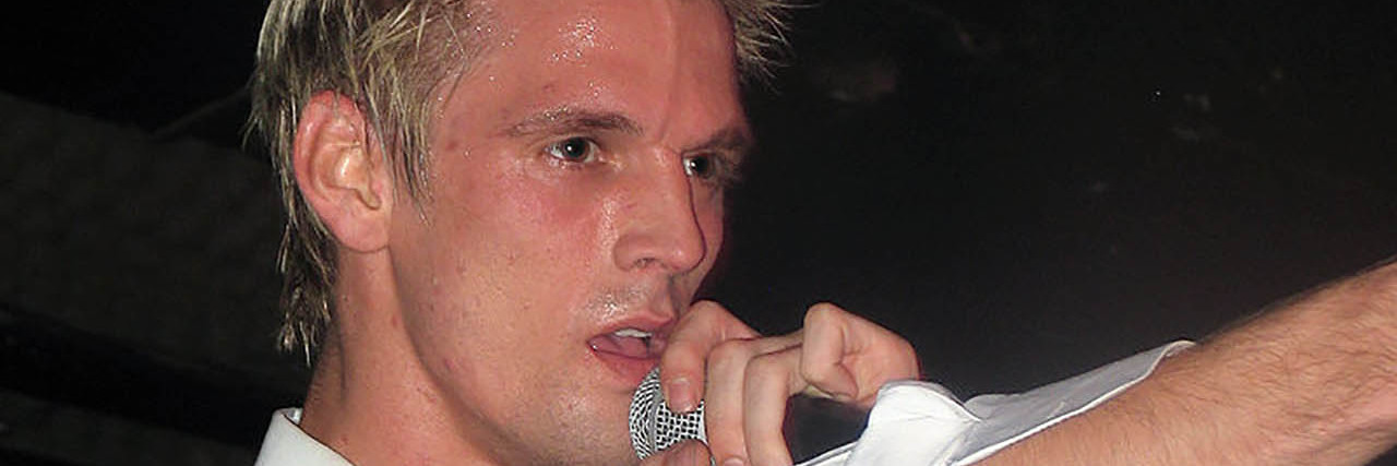 Aaron Carter singing onstage while at a concert