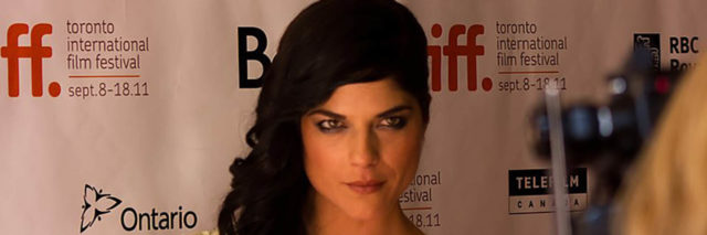 Selma Blair poses in a white sparkly dress on the red carpet