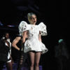 Lady Gaga sings onstage in a white dress