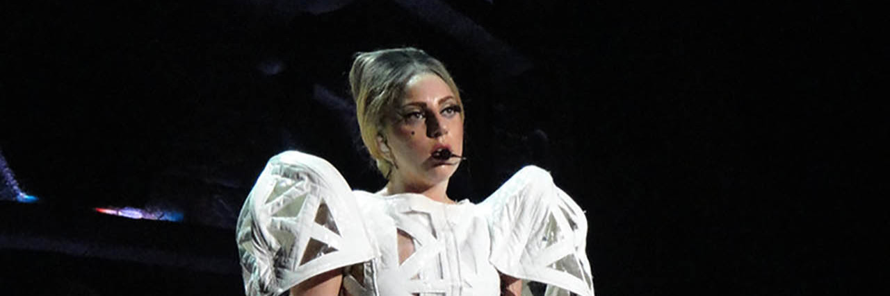 What to Know About Lady Gaga's Chronic Pain, Fibromyalgia Diagnosis Lady Gaga sings onstage in a white dress