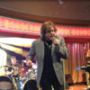 Eddie Money singing onstage with his band