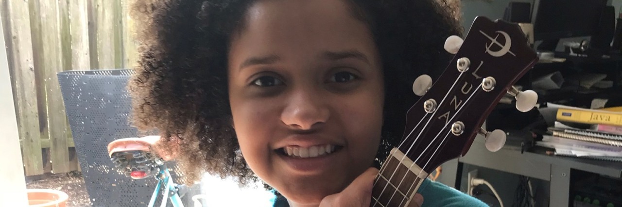 Jade holding her ukulele.