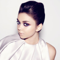 Sarah Hyland psoes in a lilac outfit with her hair pulled back
