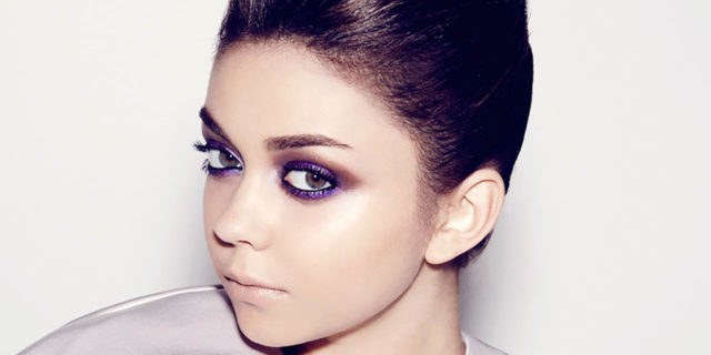 Sarah Hyland psoes in a lilac outfit with her hair pulled back