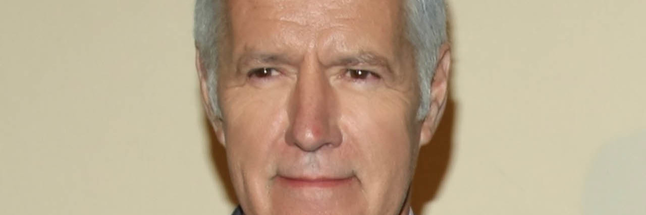 Alex Trebek poses while on the red carpet