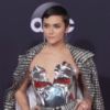 Alyson Stoner poses in a silver outfit on the red carpet