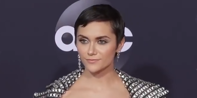 Alyson Stoner poses in a silver outfit on the red carpet