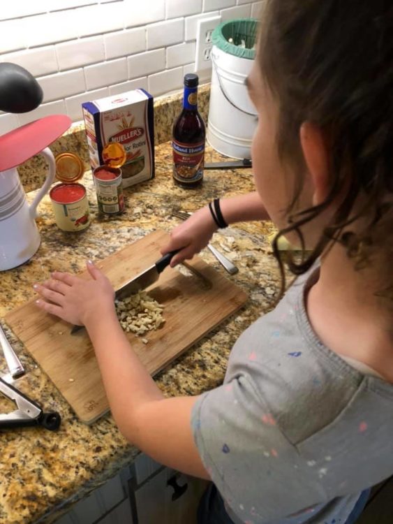 little girl learning to cook