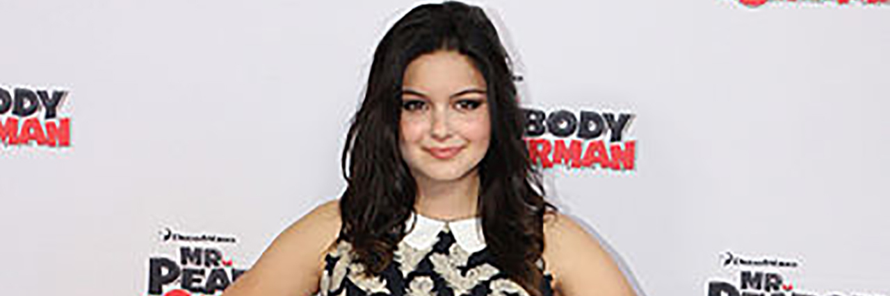 Ariel Winter poses on the red carpet while wearing a black and white dress