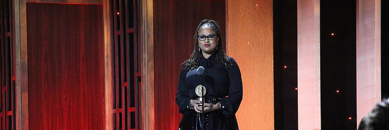 Ava DuVernay wears a black ensemble while accepting a Peabody Award.