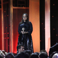 Ava DuVernay wears a black ensemble while accepting a Peabody Award.