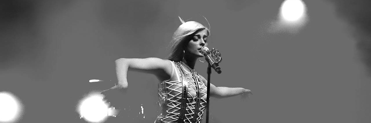 A black and white photo of Bebe Rexha performing at a concert