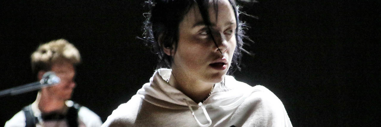 Billie Eilish Opened Up About Suicide With 'CBS This Morning' Billie Eilish sits onstage while wearing a sweatshirt
