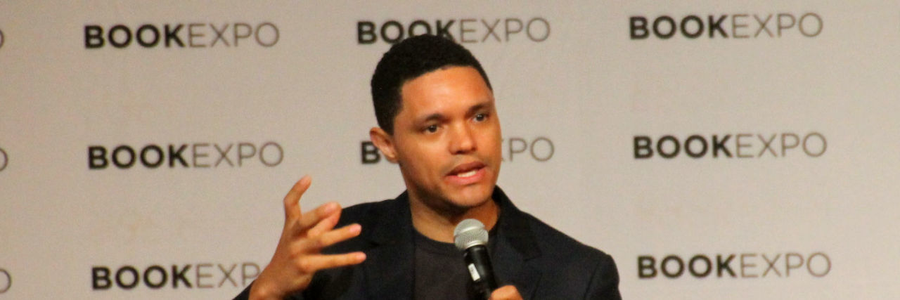 Trevor Noah Credits Jim Carrey for Helping Him Accept His Depression Trevor Noah wearing a black outfit and speaking at a BookExpo event