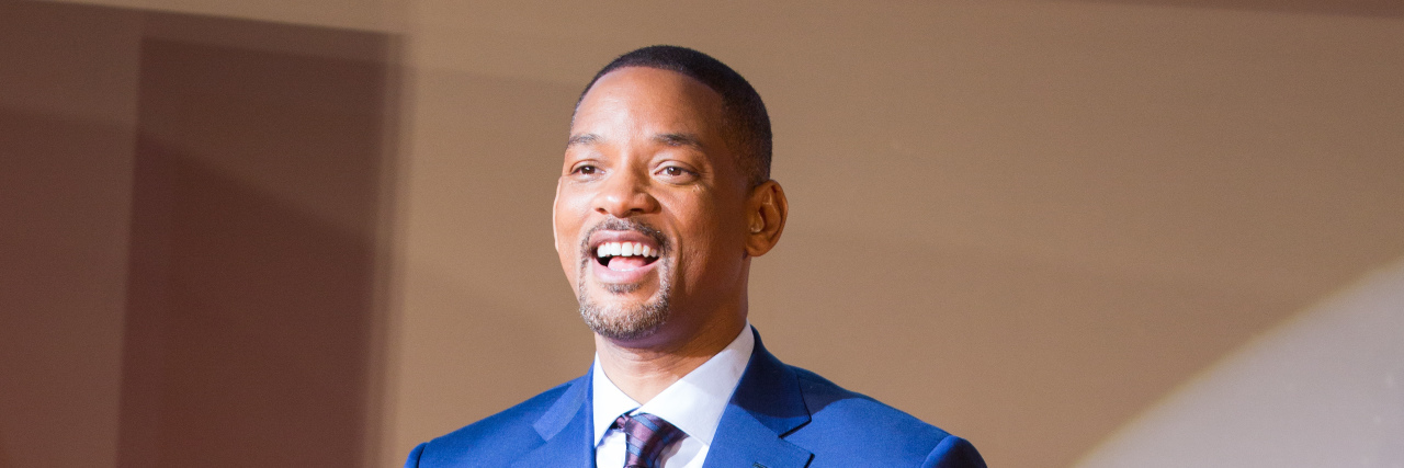 Controversial Will Smith Film Sheds Light on Disease the NFL Denied for Years Will Smith in a blue suit on the red carpet