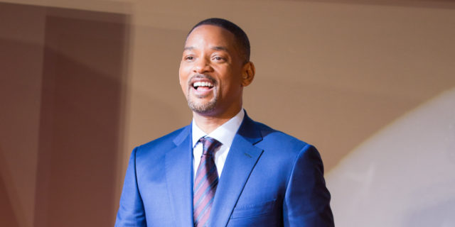 Controversial Will Smith Film Sheds Light on Disease the NFL Denied for Years Will Smith in a blue suit on the red carpet