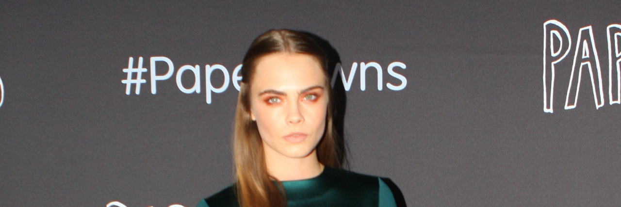 Cara Delevingne on the red carpet in a green dress