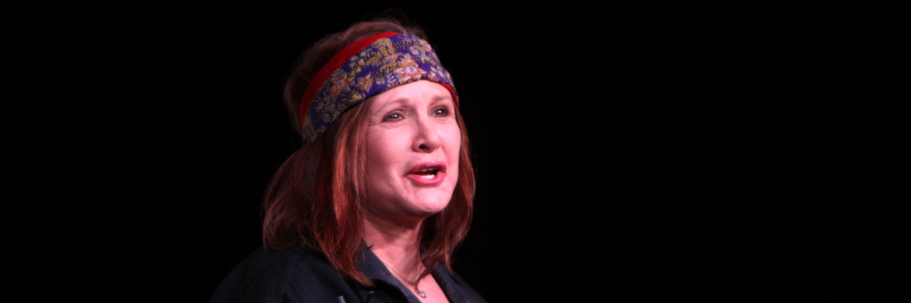 Carrie Fisher's Urn Is a Prozac Pill Carrie Fisher speaks into a crowd and is wearing black