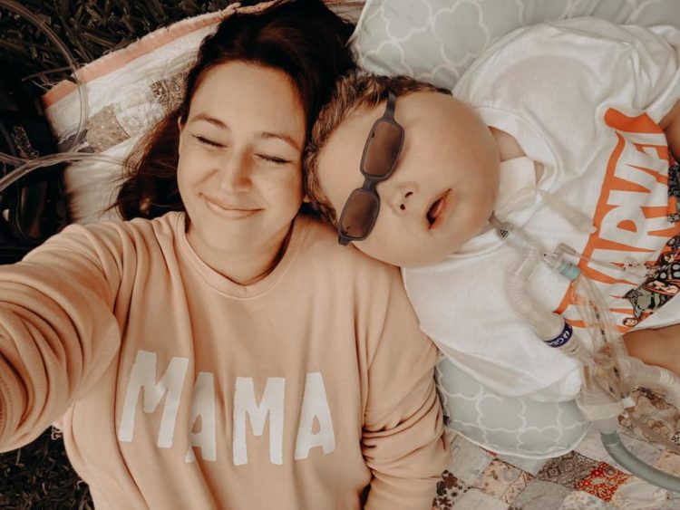 mother and son lounging in the sun 